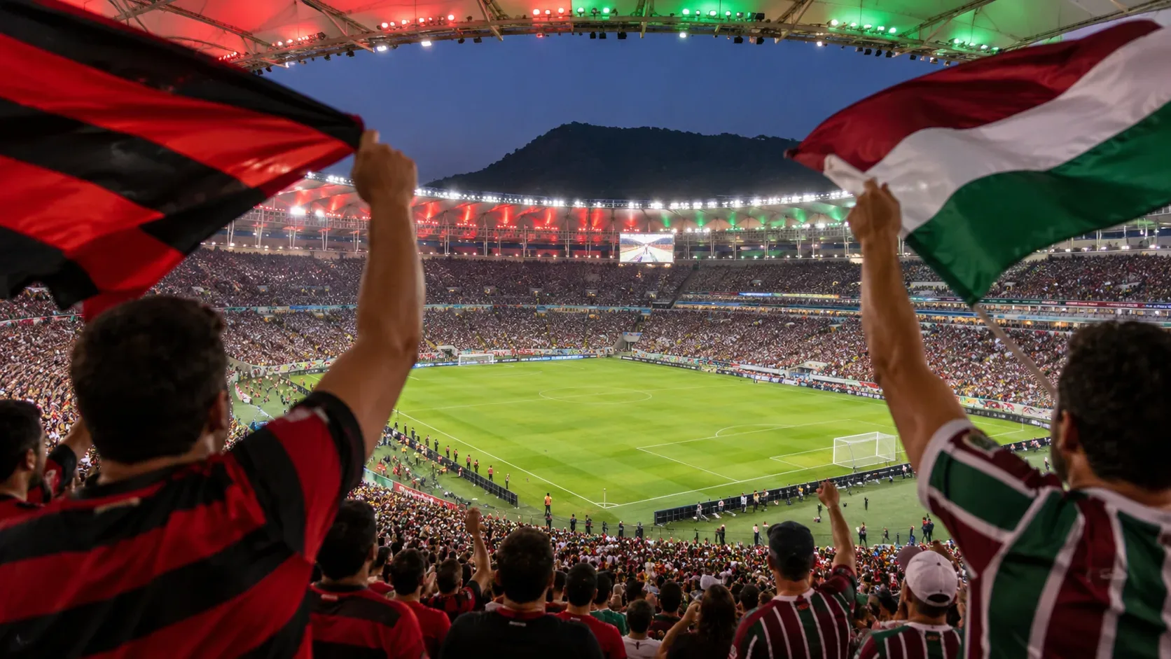 Torcedores rubro-negros e tricolores erguem bandeiras diante de um estádio lotado, com o campo ao centro e arquibancadas iluminadas.